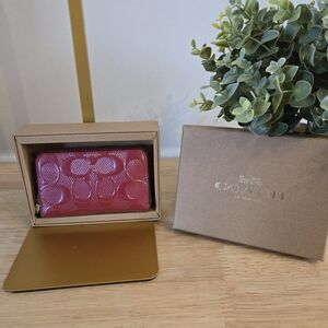 Coach Boxed Small Signature Patent Leather Zip Around Wallet.